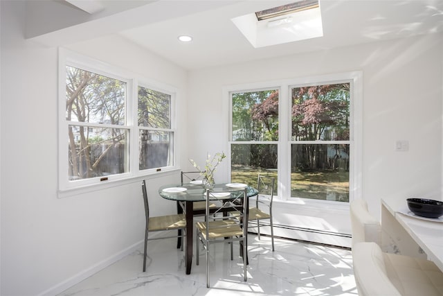 dining room featuring a skylight, healthy amount of natural light, marble finish flooring, a baseboard heating unit, and recessed lighting