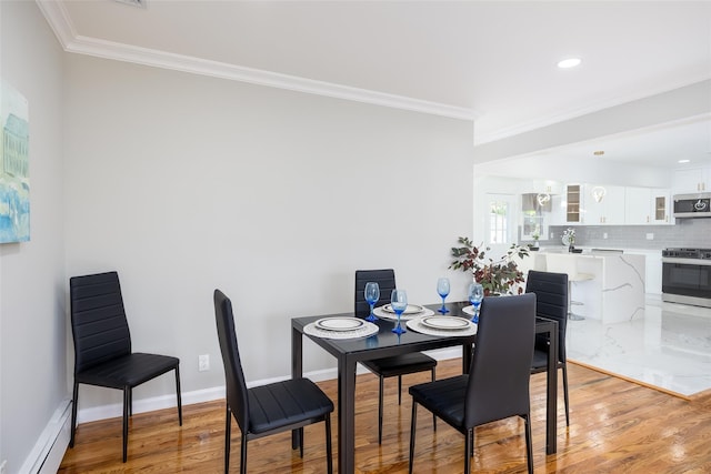 dining room featuring a baseboard radiator, ornamental molding, light wood-style floors, baseboards, and recessed lighting