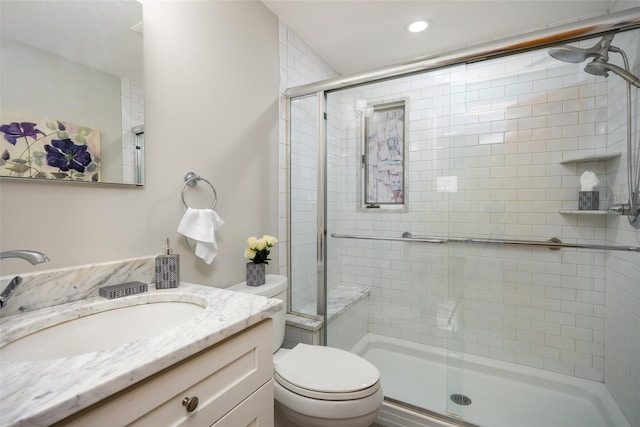full bath featuring a shower stall, toilet, vanity, and recessed lighting