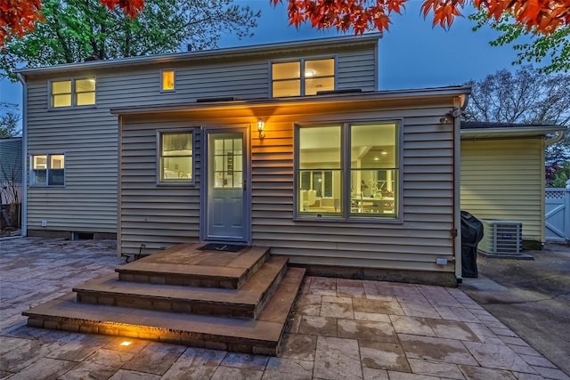 rear view of property with cooling unit and a patio area