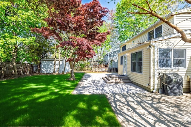 view of yard with a patio area and an outdoor structure
