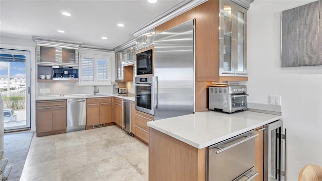 575 Dune Rd Unit 36And 37, Westhampton Beach, NY 11978 - kitchen featuring beverage cooler, built in appliances, light countertops, glass insert cabinets, and recessed lighting