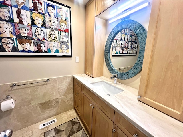 575 Dune Rd Unit 36And 37, Westhampton Beach, NY 11978 - bathroom featuring vanity, wainscoting, and tile walls