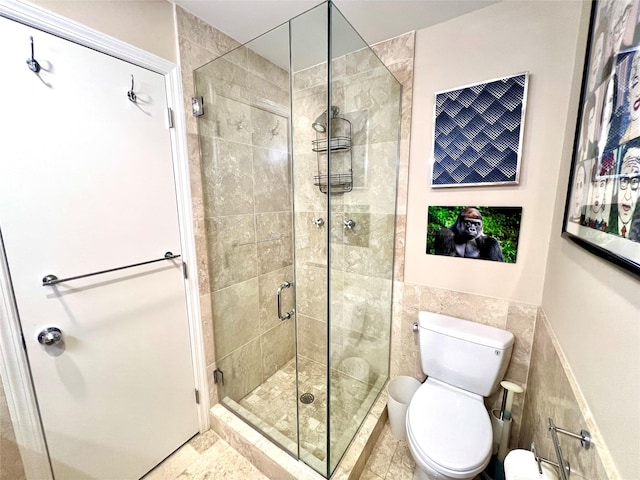 575 Dune Rd Unit 36And 37, Westhampton Beach, NY 11978 - bathroom featuring a shower stall, tile walls, toilet, and a wainscoted wall