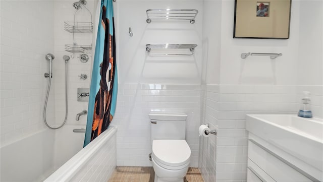 575 Dune Rd Unit 36And 37, Westhampton Beach, NY 11978 - full bath with tile walls, toilet, shower / tub combo with curtain, vanity, and wainscoting