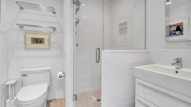 575 Dune Rd Unit 36And 37, Westhampton Beach, NY 11978 - bathroom with tile walls, a stall shower, vanity, and toilet