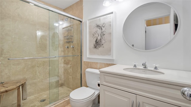 575 Dune Rd Unit 36And 37, Westhampton Beach, NY 11978 - bathroom with a shower stall, toilet, vanity, and tile walls