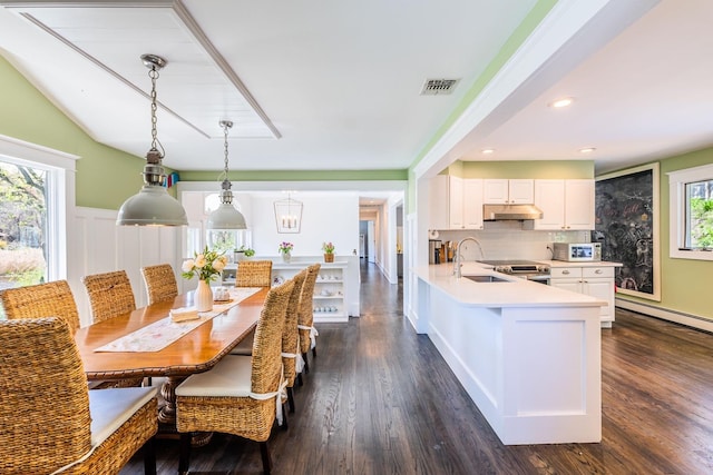 60 Bayview Dr, Huntington, NY 11743 - kitchen with under cabinet range hood, visible vents, a sink, white cabinetry, and light countertops