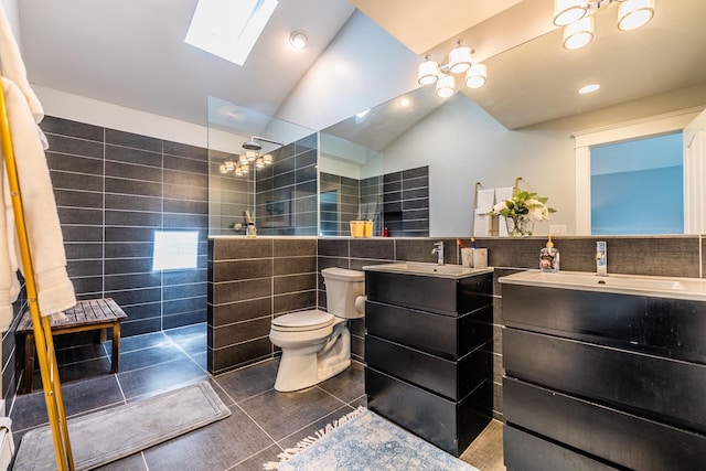 60 Bayview Dr, Huntington, NY 11743 - bathroom with toilet, tile walls, lofted ceiling with skylight, tile patterned flooring, and two vanities