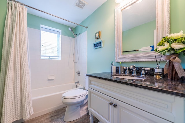 60 Bayview Dr, Huntington, NY 11743 - full bathroom with toilet, wood finished floors, shower / bath combo, visible vents, and vanity