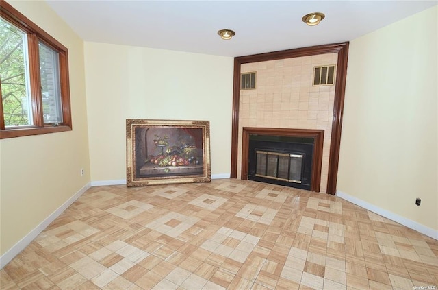 unfurnished living room featuring a fireplace, baseboards, and visible vents