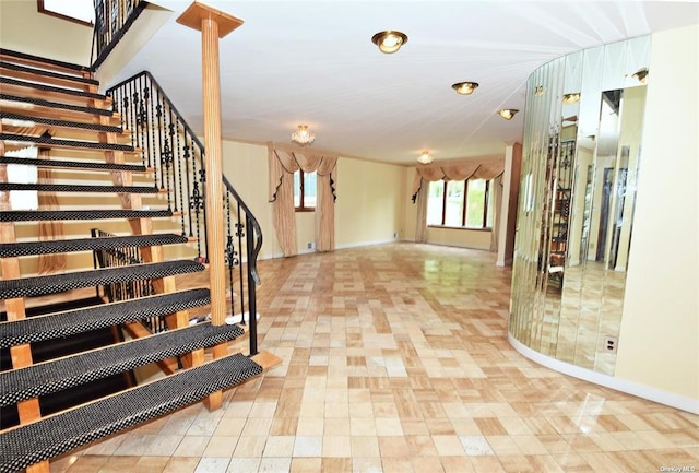 interior space with stairs and baseboards