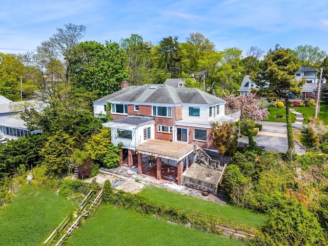 22 Shorecliff Pl, Great Neck, NY 11023 - rear view of property with a wooden deck, a chimney, and brick siding