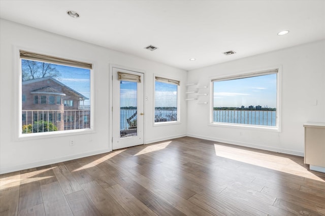 22 Shorecliff Pl, Great Neck, NY 11023 - unfurnished room featuring plenty of natural light, visible vents, and baseboards