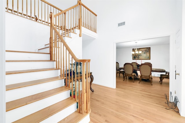 14 Clarks Ln, Milton, NY 12547 - stairway featuring wood finished floors, a chandelier, a towering ceiling, and baseboards
