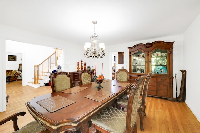 14 Clarks Ln, Milton, NY 12547 - dining area featuring stairs, light wood-type flooring, and a chandelier