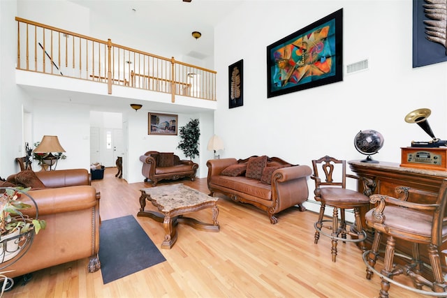 14 Clarks Ln, Milton, NY 12547 - living room with wood finished floors, a high ceiling, and a baseboard heating unit