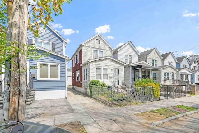 multi unit property with a fenced front yard and a residential view