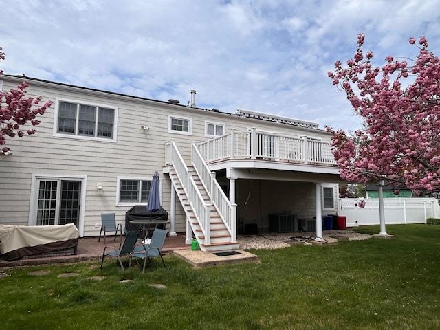 36 Shore Dr W, Copiague, NY 11726 - back of property featuring a lawn, fence, central AC, stairs, and a wooden deck