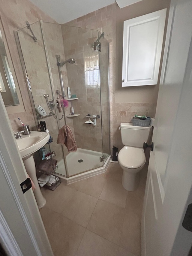 36 Shore Dr W, Copiague, NY 11726 - full bathroom featuring tile patterned floors, toilet, tile walls, and a shower stall