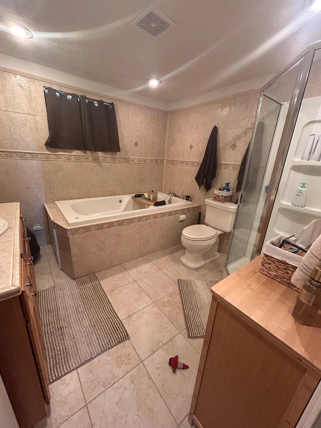 36 Shore Dr W, Copiague, NY 11726 - full bath with tile walls, toilet, visible vents, a garden tub, and vanity