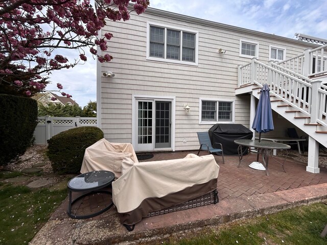 36 Shore Dr W, Copiague, NY 11726 - rear view of house featuring stairs, a patio, fence, and a wooden deck