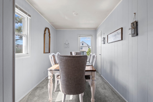 9702 159th Ave, Howard Beach, NY 11414 - dining area featuring light colored carpet, crown molding, and baseboards