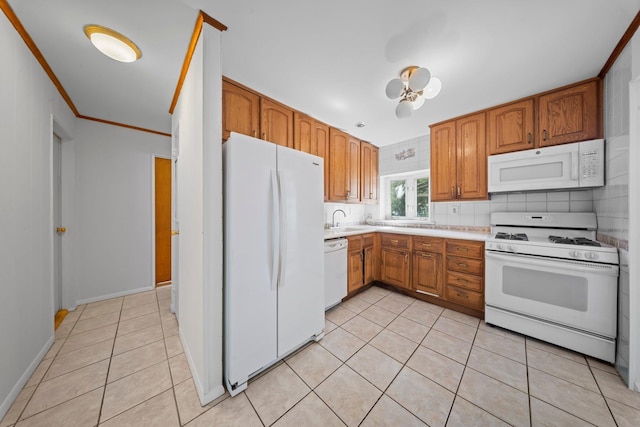 9702 159th Ave, Howard Beach, NY 11414 - kitchen with white appliances, light tile patterned flooring, a sink, light countertops, and ornamental molding