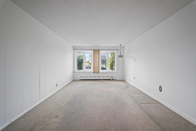 9702 159th Ave, Howard Beach, NY 11414 - unfurnished room with a baseboard radiator, carpet floors, and baseboards