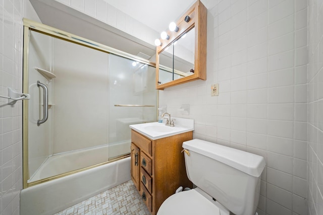 9702 159th Ave, Howard Beach, NY 11414 - bathroom with toilet, vanity, combined bath / shower with glass door, and tile walls