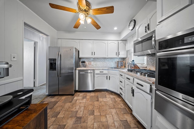 9702 159th Ave, Howard Beach, NY 11414 - kitchen with stainless steel appliances, a warming drawer, a sink, backsplash, and recessed lighting