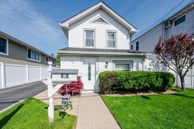 view of front of home featuring fence and a front yard