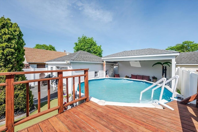view of swimming pool featuring fence, a wooden deck, and a fenced in pool