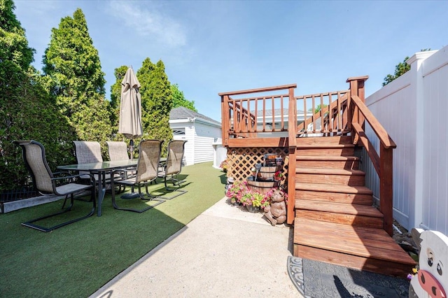 view of yard with a patio area, outdoor dining area, and stairs