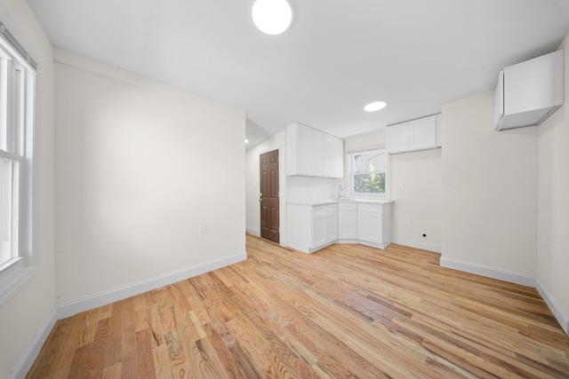 119-47 191st St, Saint Albans, NY 11412 - interior space with light wood finished floors, baseboards, and a sink