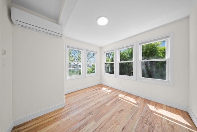 119-47 191st St, Saint Albans, NY 11412 - empty room with baseboards, a wall mounted air conditioner, and wood finished floors