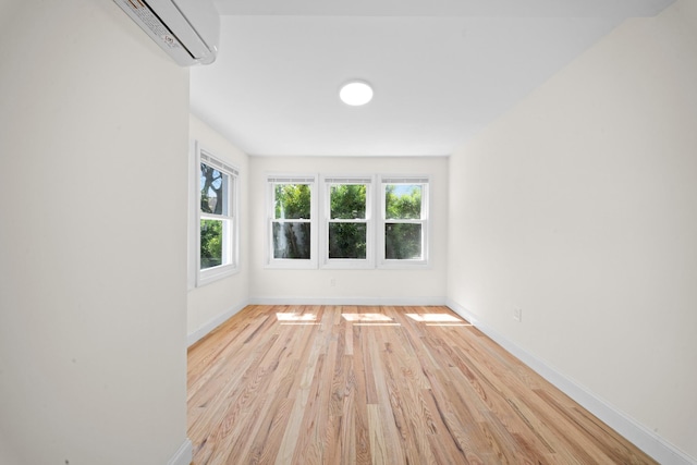 119-47 191st St, Saint Albans, NY 11412 - spare room featuring baseboards, light wood-style floors, and a wall unit AC