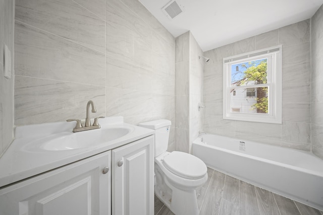 119-47 191st St, Saint Albans, NY 11412 - full bath with tile walls, toilet, visible vents, vanity, and wood finished floors
