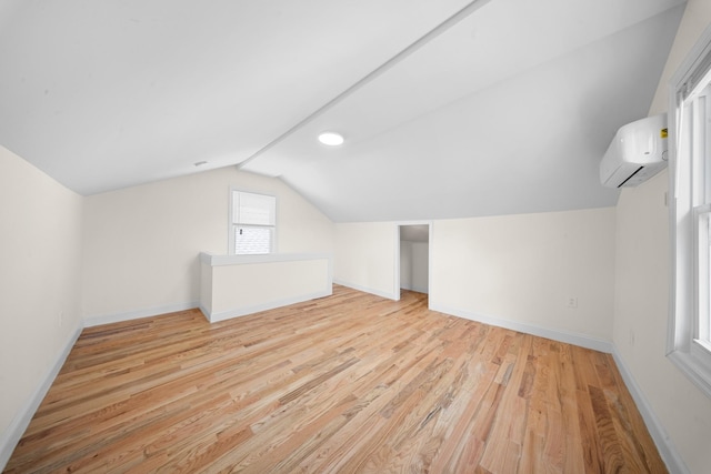 119-47 191st St, Saint Albans, NY 11412 - bonus room with vaulted ceiling, an AC wall unit, baseboards, and light wood-type flooring