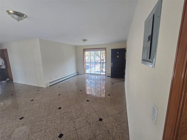 empty room featuring electric panel, baseboards, baseboard heating, and granite finish floor