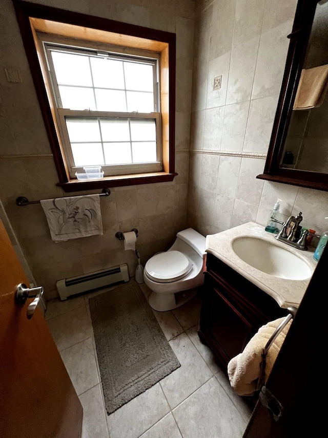 bathroom featuring tile walls, a baseboard radiator, toilet, tile patterned floors, and vanity