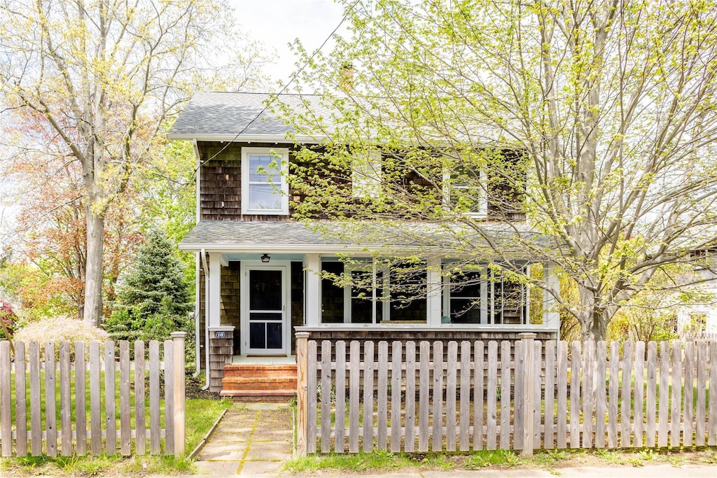 16 Washington Ave, Greenport, NY 11944 - traditional home featuring covered porch and a shingled roof