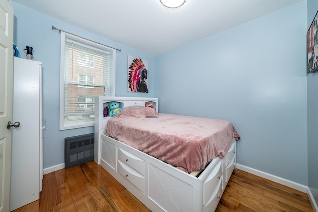 90 Union St Unit 1A, New Rochelle, NY 10801 - bedroom with radiator, wood finished floors, and baseboards
