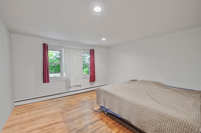 1564 Illinois Ave, Bay Shore, NY 11706 - bedroom with a baseboard radiator, light wood-style flooring, and recessed lighting