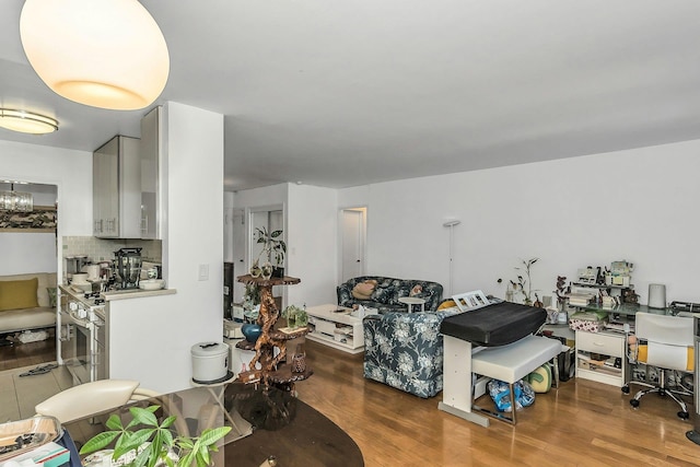 138-10 Franklin Ave Unit 9J, Flushing, NY 11355 - living room featuring wood finished floors, a desk, and a chandelier