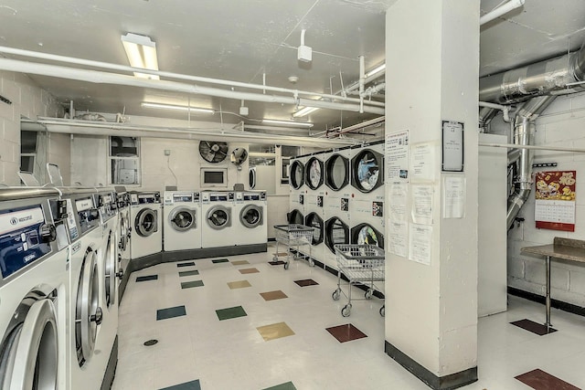 138-10 Franklin Ave Unit 9J, Flushing, NY 11355 - shared laundry room featuring independent washer and dryer, tile patterned floors, and estacked washer and dryer