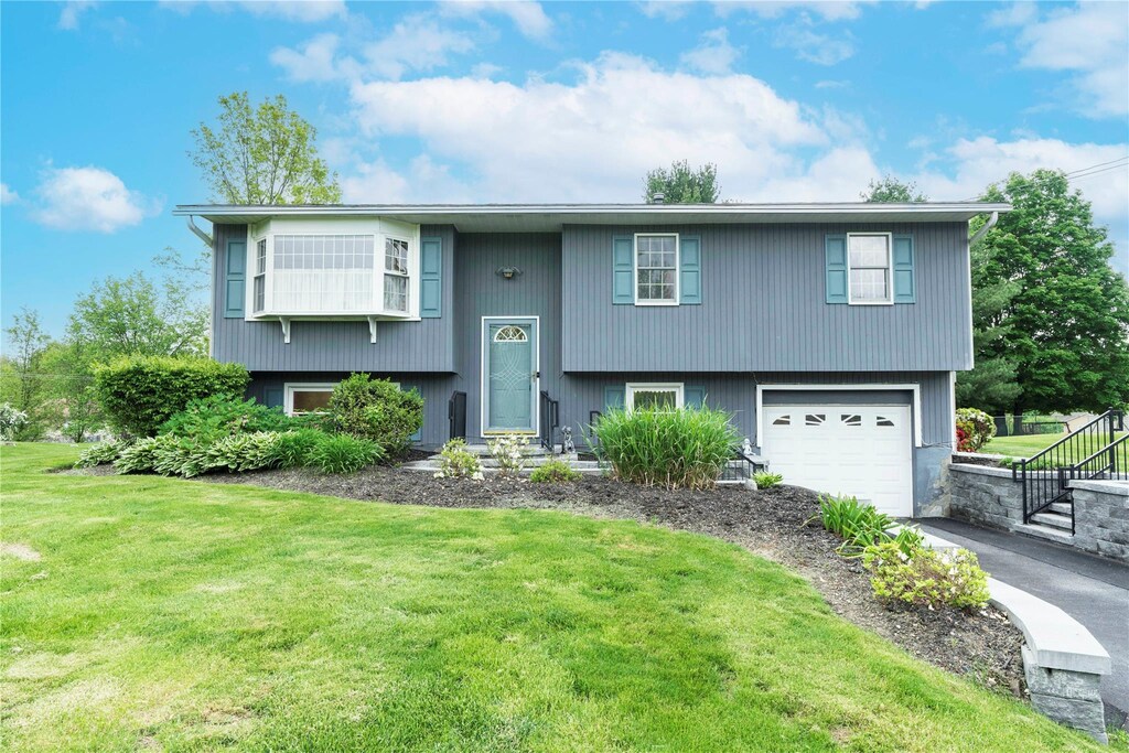 190 Lakeside Rd, Newburgh, NY 12550 - bi-level home featuring asphalt driveway, an attached garage, and a front yard