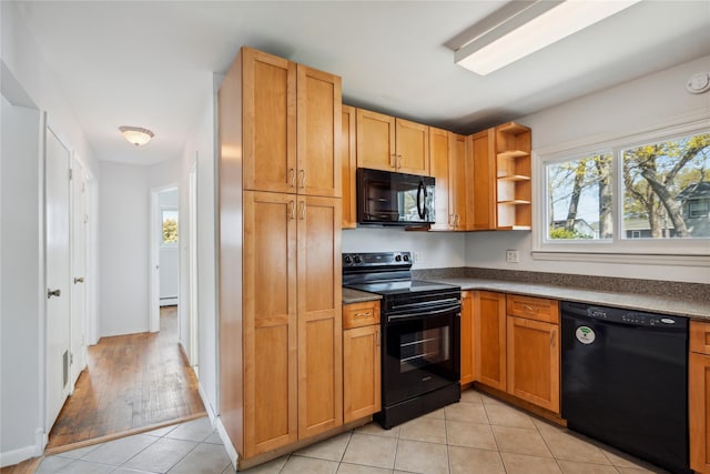 kitchen featuring black appliances, open shelves, dark countertops, light tile patterned flooring, and baseboards