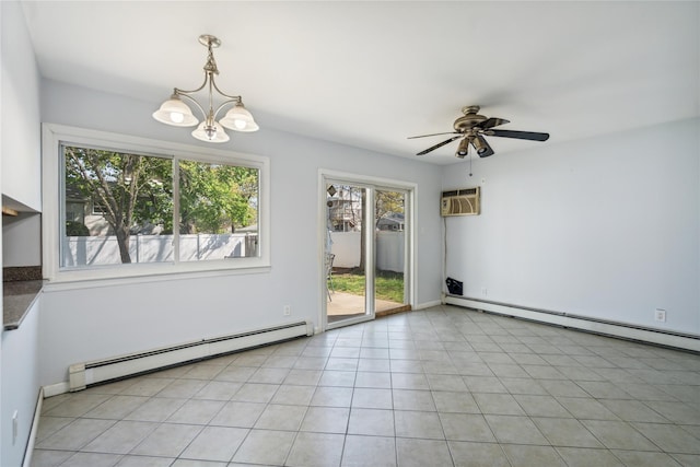 unfurnished room with a baseboard heating unit, healthy amount of natural light, and a chandelier