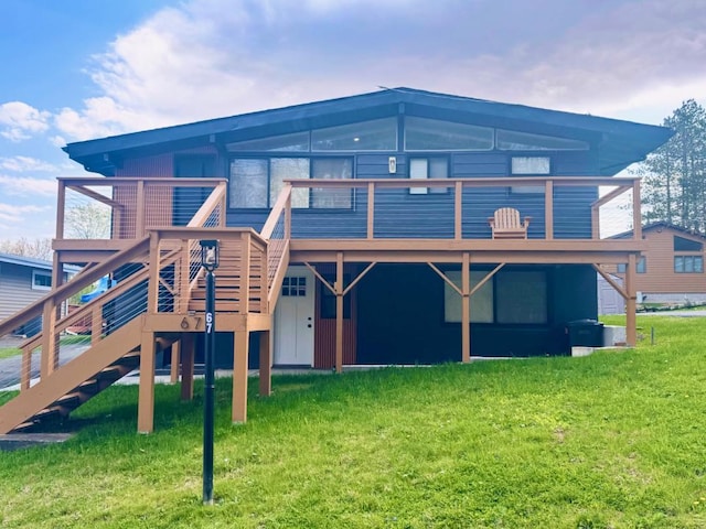 back of property with a lawn and a deck